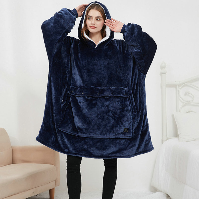 Woman wearing the navy Hoodgrove heated hoodie blanket with the sherpa-lined hood up